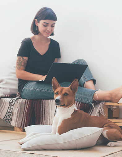 female working remotely from home with dog